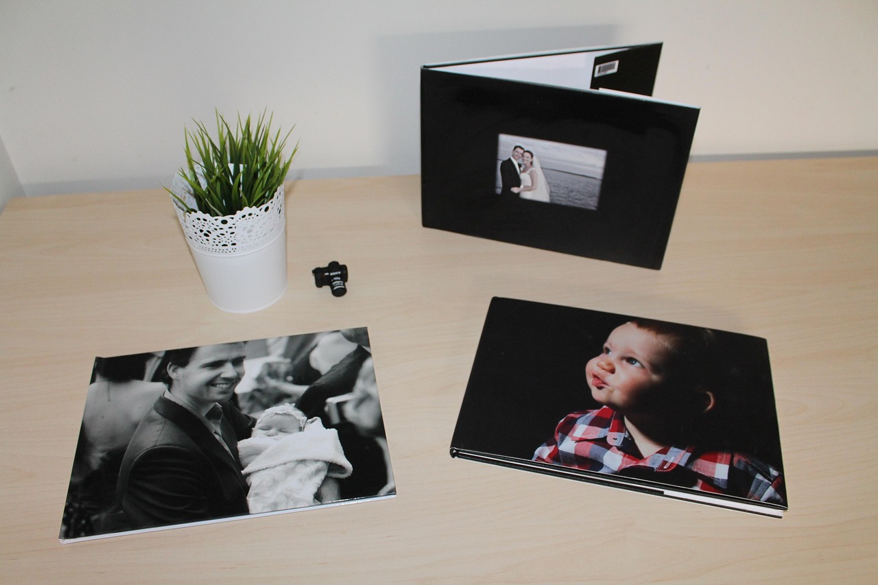 Three hardcover photobooks displayed on a table.