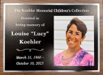 A memorial plaque with a photo of a woman.