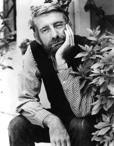 A black and white photograph of a bearded man - Rod McKuen.