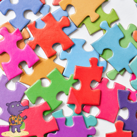 Bright, multicolored puzzle pieces scattered in the picture.