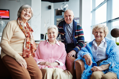 A group of senior citizens posing for a group photo.