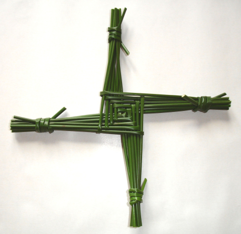A traditional St. Brigid's Cross made with dark green Irish rushes.