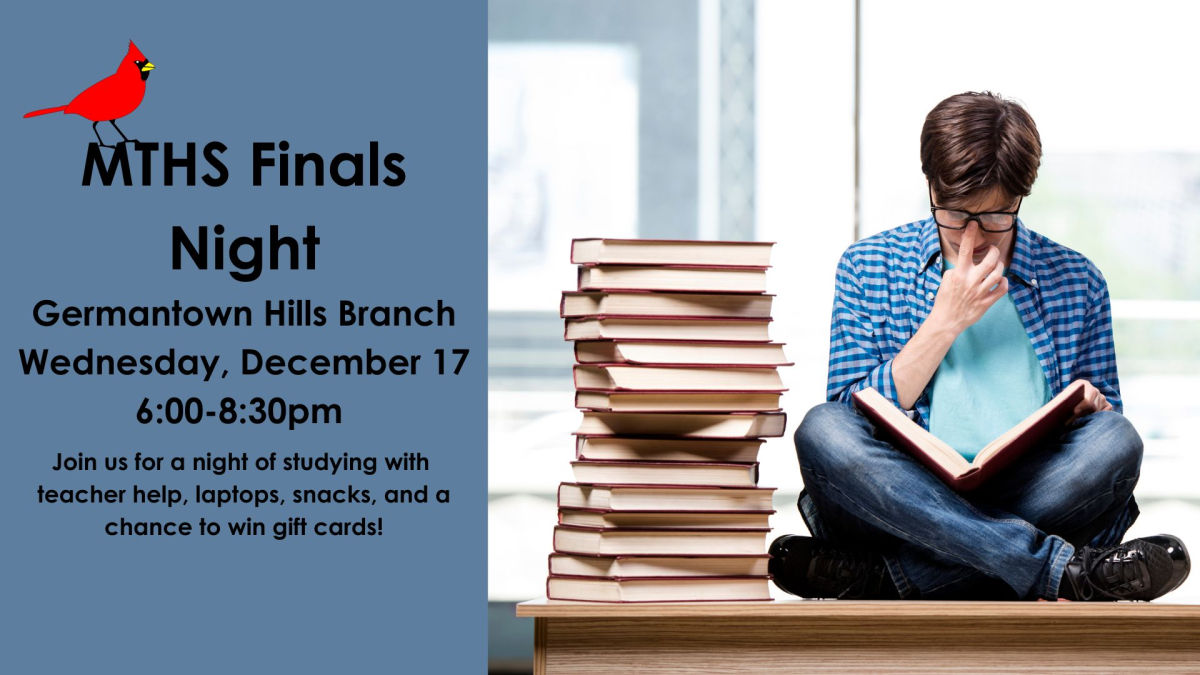 A teen sitting on a desk next to a stack of books holding an open book.